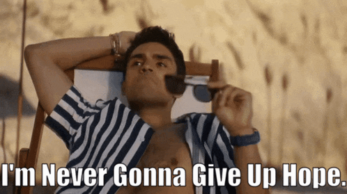 a man in a striped shirt is laying in a beach chair with the words i 'm never gonna give up hope