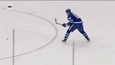 a hockey player with the number 91 on his jersey celebrates a goal