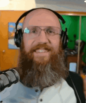 a man with a beard and glasses is wearing headphones