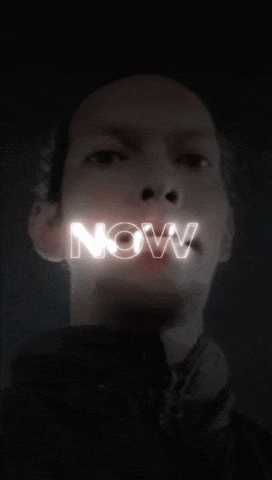 a man 's face is lit up with the word down above it