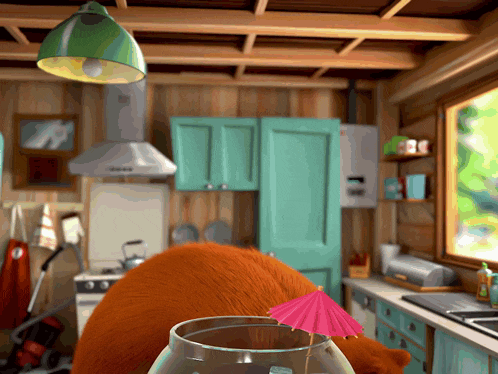 a kitchen with a glass with a pink umbrella on it