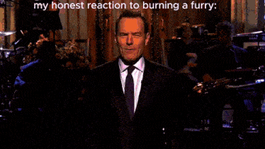 a blurred image of a man in a suit and tie with the words " my honest reaction to burning a furry " below him