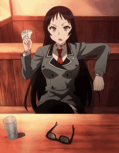 a girl is sitting at a table with glasses and a glass of water