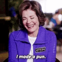 a woman wearing a purple jacket is laughing and saying `` i made a pun '' .