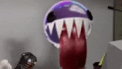 a close up of a toy with a shark 's mouth and teeth on it .