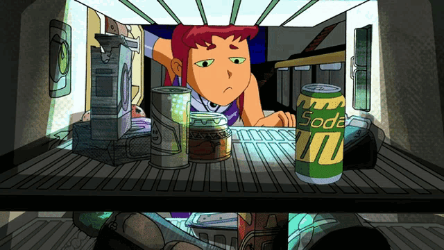 a can of soda sits on the bottom shelf of a fridge