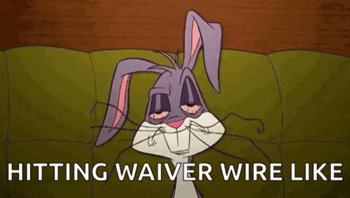 bugs bunny is sitting on a couch with a mask on his face and the words `` hitting waiver wire like '' .