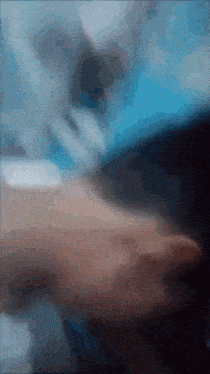 a blurry picture of a person 's face with a blue sky in the background