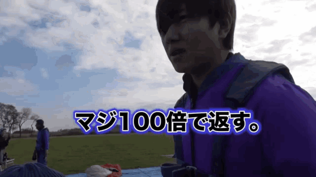 a man in a purple jacket stands in a field with the words 100 written in blue letters
