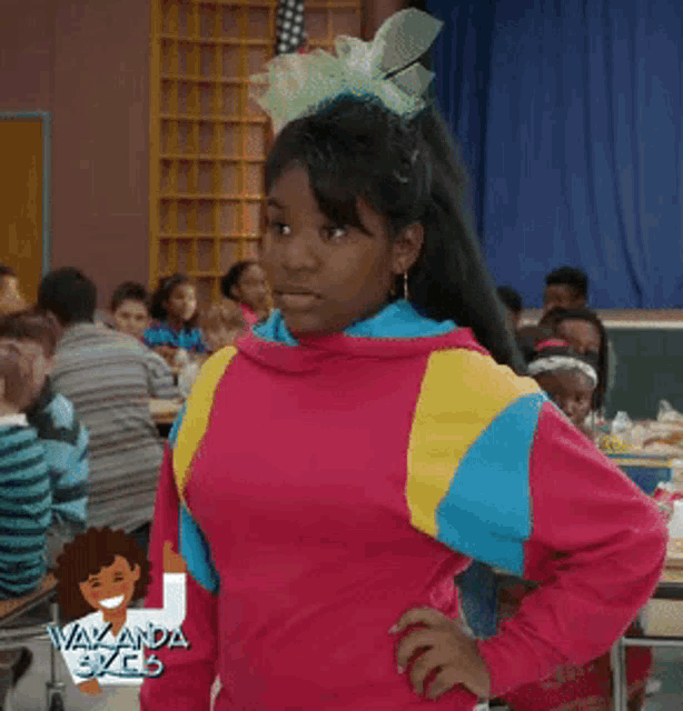 a girl in a pink and blue sweater is standing in front of a group of children and says excuse me