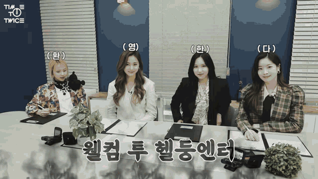 a group of girls are sitting at a table with their names written on them