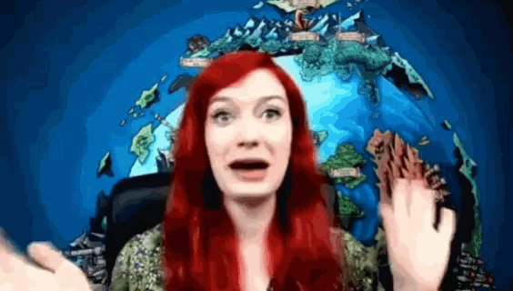 a woman with red hair is standing in front of a map of the world with the letters a and b on it