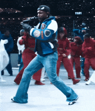 a man in a varsity jacket with the letter t on it