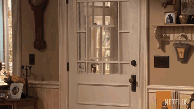 a netflix sign hangs on a shelf in a living room