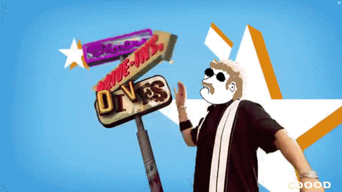 a man stands in front of a drive-in sign that says drive-ins