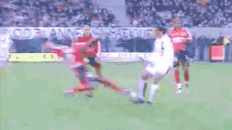 a group of soccer players are playing on a field with a sign that says ' inee ' on it