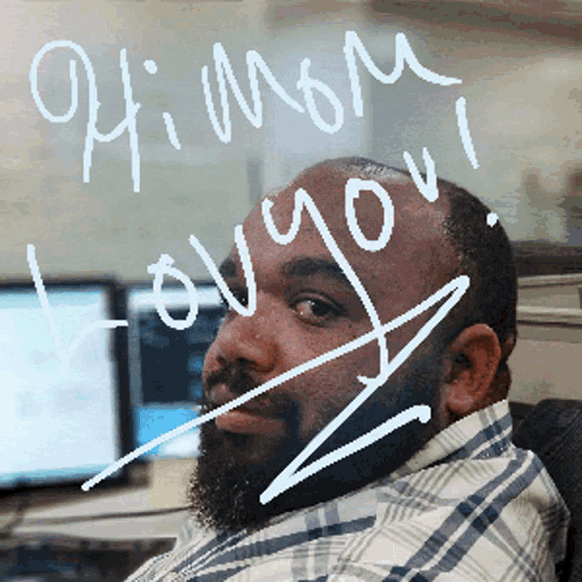 a man in a plaid shirt says hi mom i love you on a glass