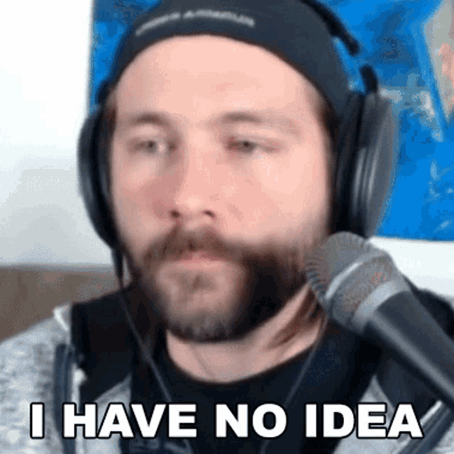 a man with a beard is wearing headphones and a microphone .