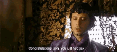 a man in a purple shirt is saying congratulations son you just had sex .