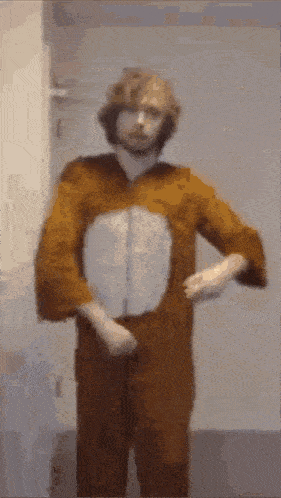 a man in a bunny costume is standing in front of a door .