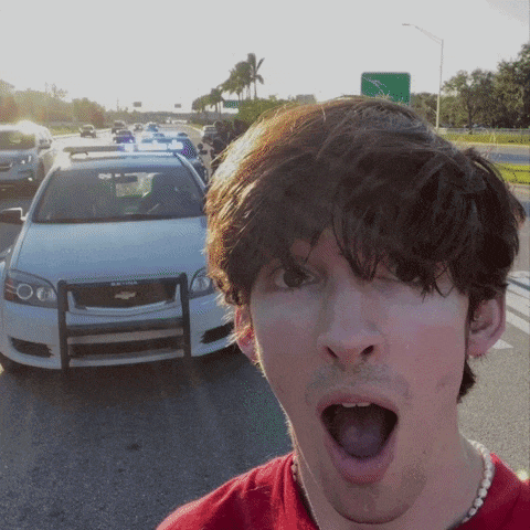 a man taking a selfie in front of a chevrolet