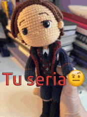 a person is holding a crocheted doll with the words " tu seria " on it