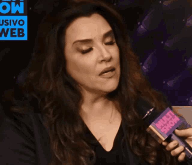 a woman holds a microphone that says multi show