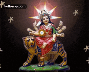 a statue of a woman sitting on top of a tiger