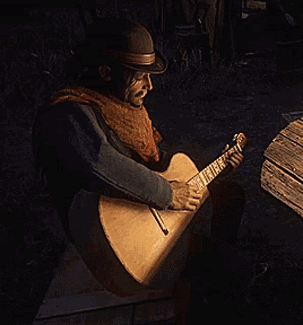 a man in a hat is playing an acoustic guitar in the dark