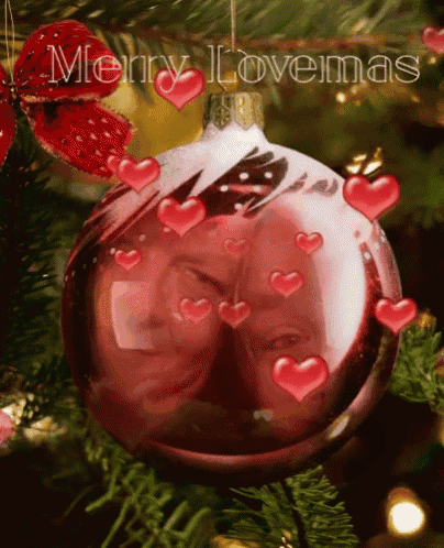 a merry lovemas greeting card with a christmas ornament on a tree