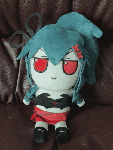 a stuffed doll with scissors in her hair and red eyes