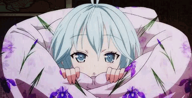 a girl with blue eyes is wrapped in a purple blanket .