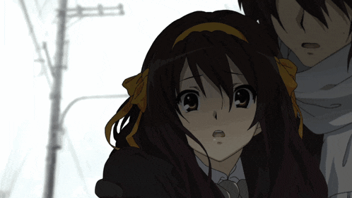 a boy and a girl are standing next to each other and the girl has a surprised look on her face