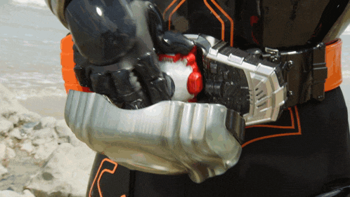a close up of a person 's belt with a red button on it