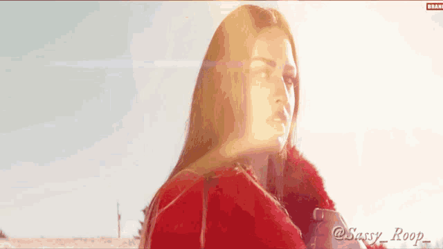 a woman in a red coat with the name sassy roop