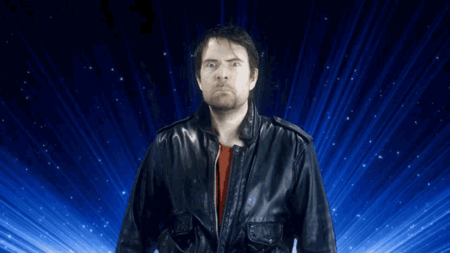 a man in a leather jacket is standing in front of a blue background that says euuuuh