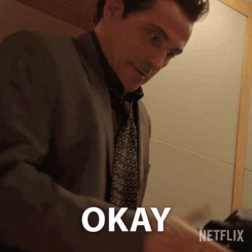 a man in a suit and tie says okay in a netflix ad