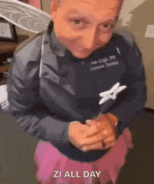 a man in a fairy costume is holding a toothbrush and a pink skirt .