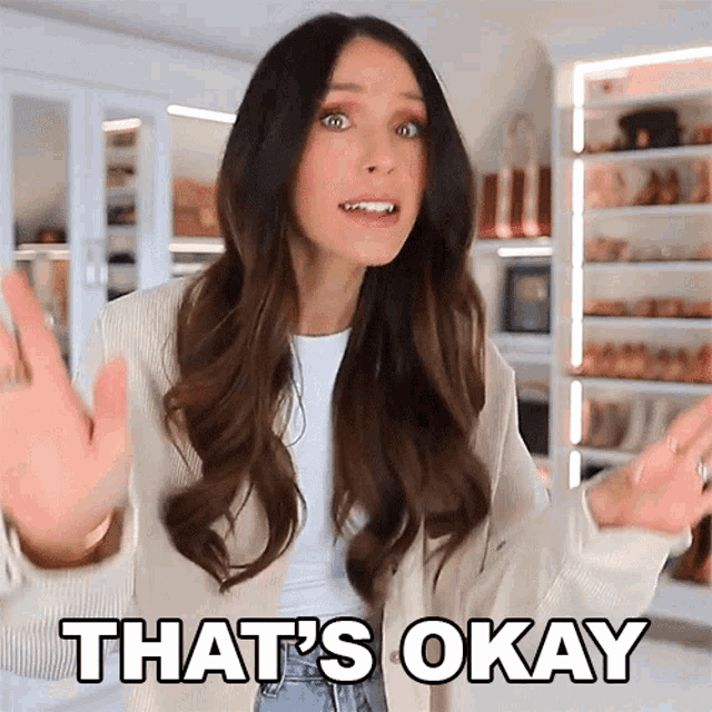 a woman is saying that 's okay with her hands outstretched