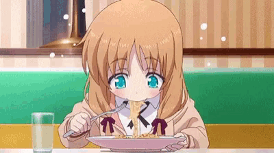 a girl is eating spaghetti with a fork and spoon