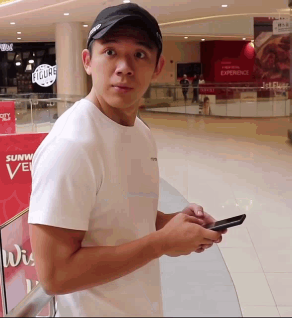a man standing in front of a sign that says sunway avenue