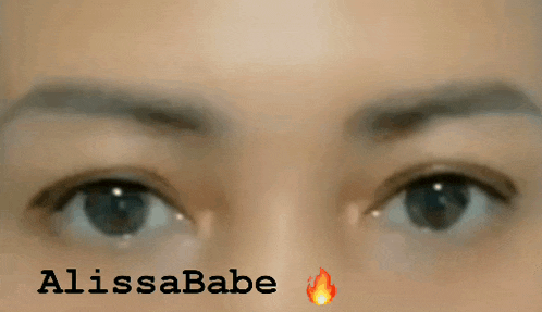 a close up of a woman 's eyes with the name alissababe written below them