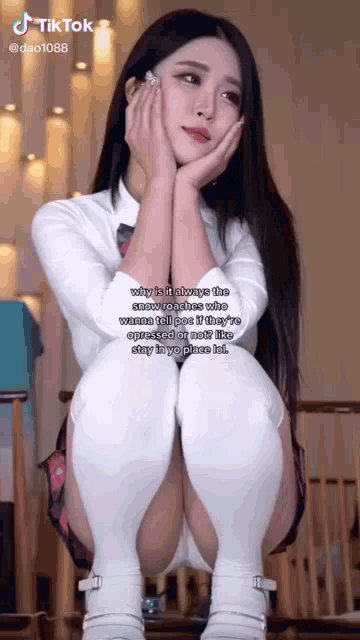 a girl in a school uniform is sitting on a chair with her legs crossed