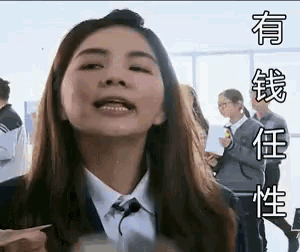 a woman in a suit and tie is making a funny face while holding a piece of paper in her hand .