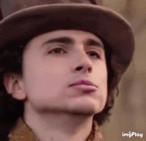 a close up of a man 's face wearing a top hat