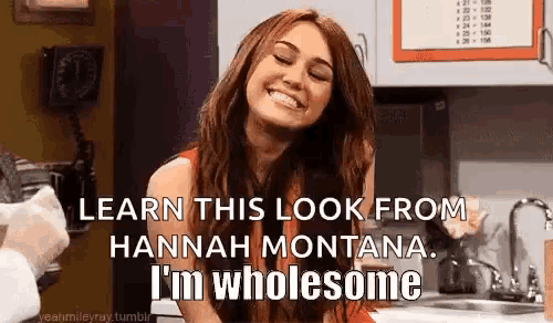 a woman is smiling in a kitchen and says `` learn this look from hannah montana , i 'm wholesome '' .