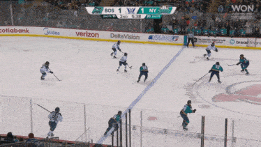 a hockey game is being played with ads for verizon and deltavision
