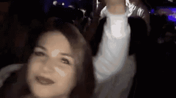a man and a woman are dancing in a dark room .