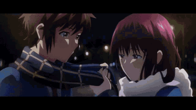 a boy and a girl are holding hands and looking at each other . the girl is wearing a scarf around her neck .