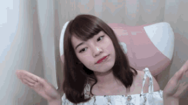 a young woman is sitting in a chair with her arms outstretched